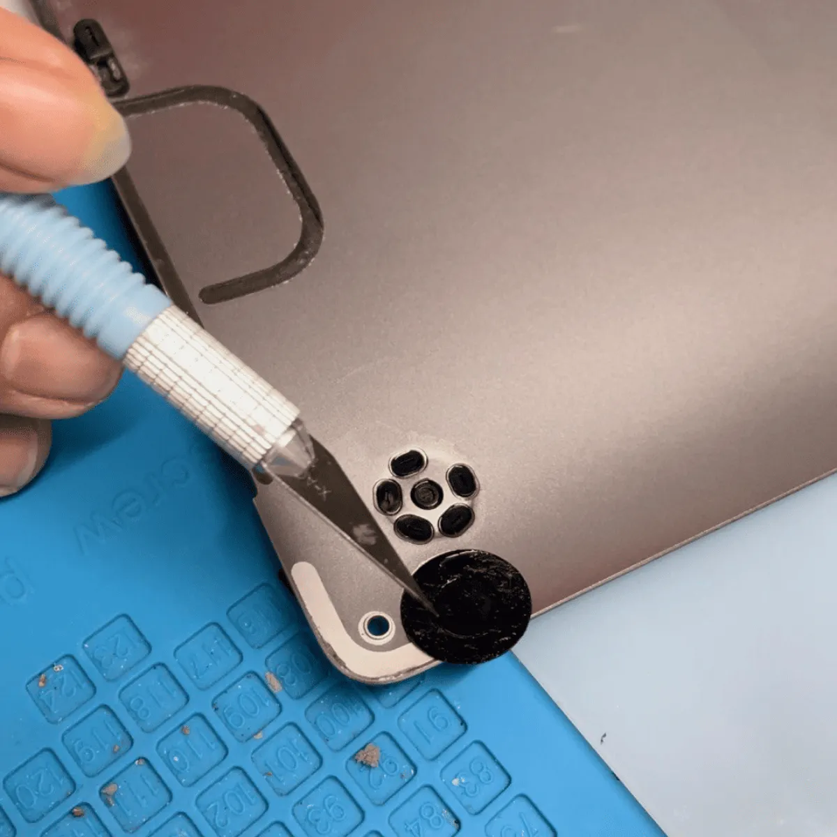 Bottom case lifted to reach the keyboard and trackpad assembly